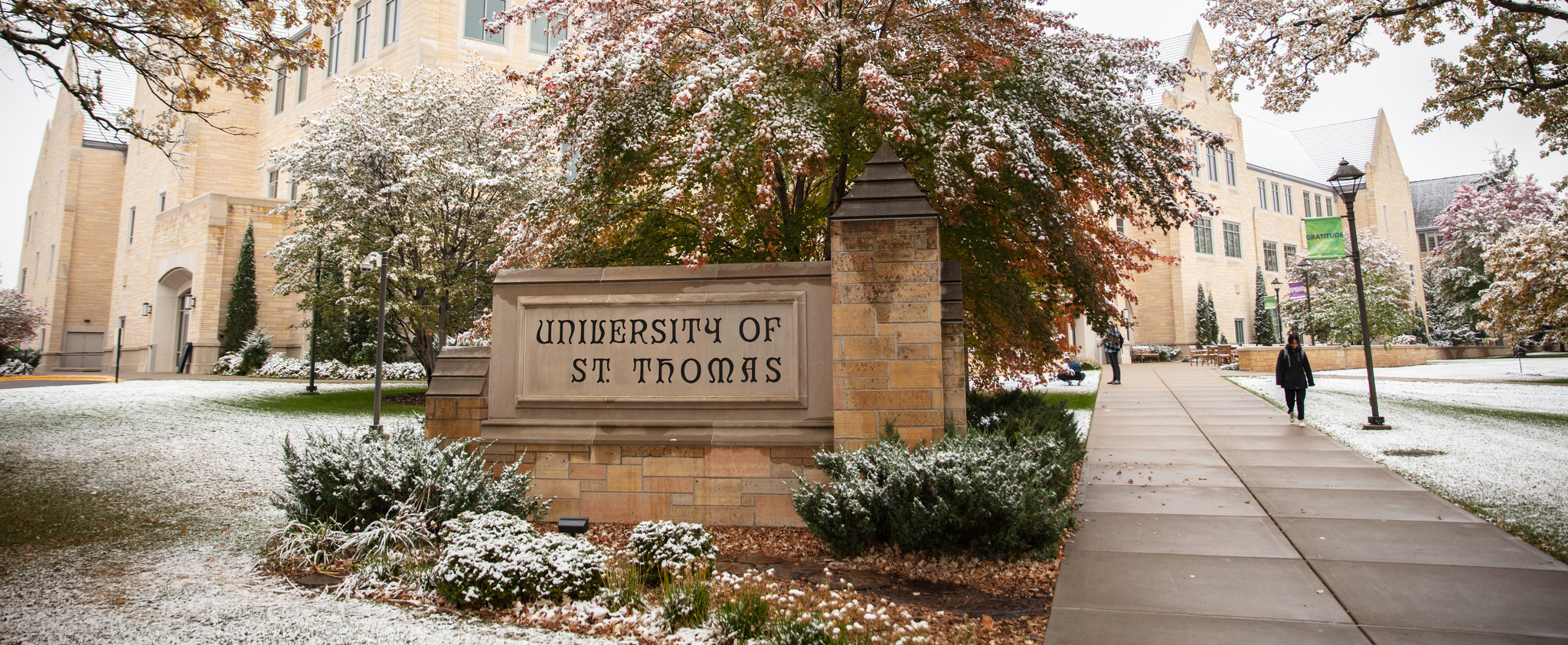 St. Thomas sign in front of Anderson Student Center with a light dusting of snow